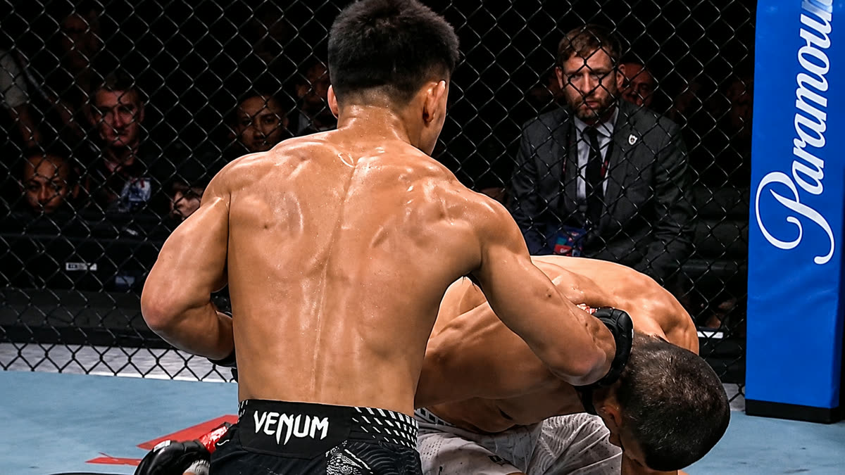 Song Yadong stands over Umar Nurmagomedov as he falls.