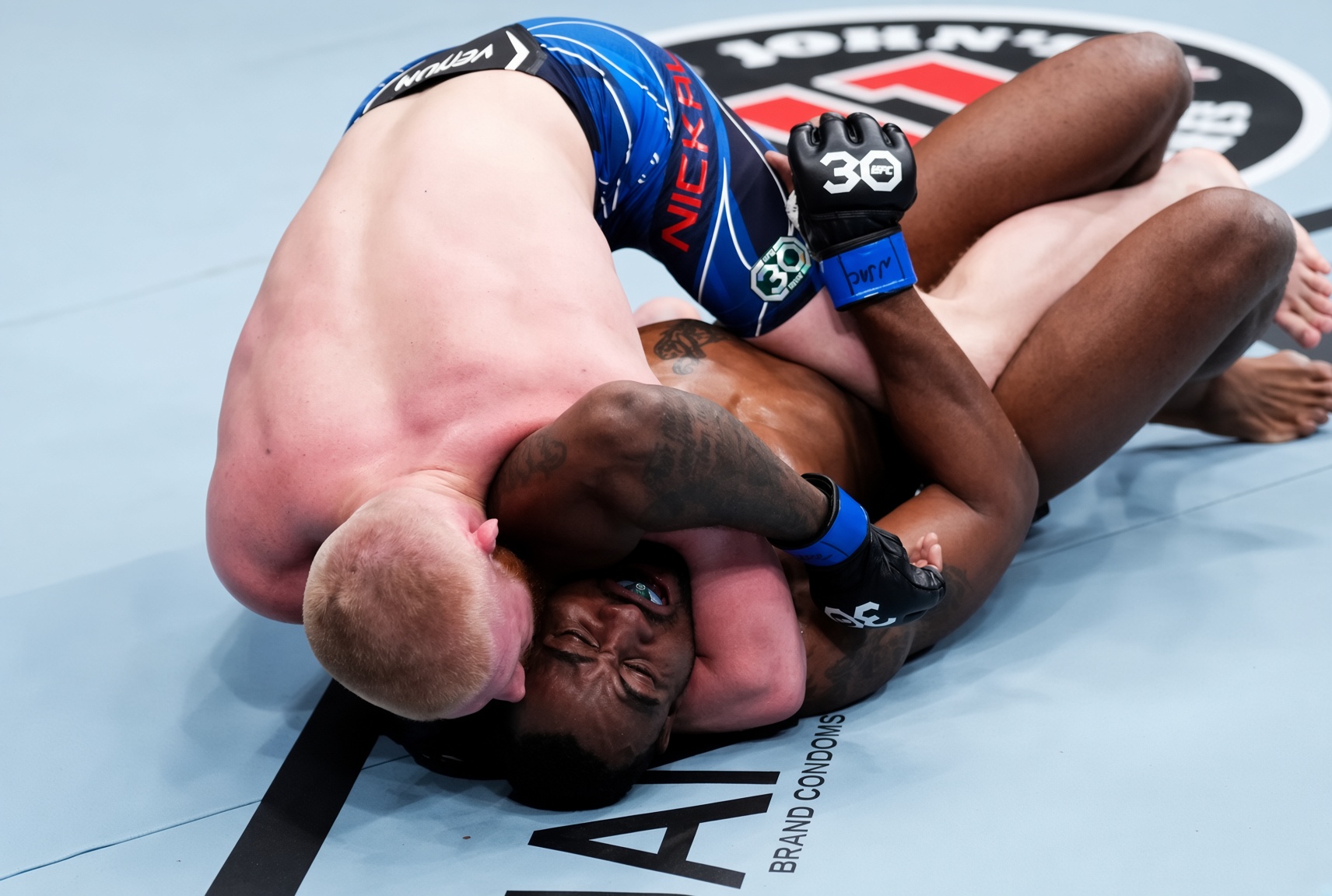 A fighter finishing an arm triangle from the top.