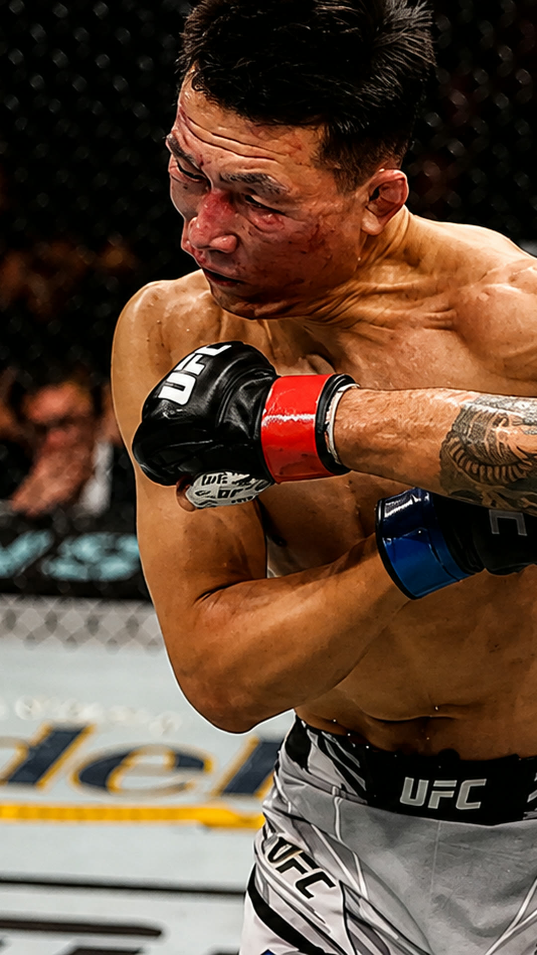 Chan Sung Jung, face marked, exchanging with Alexander Volkanovski.
