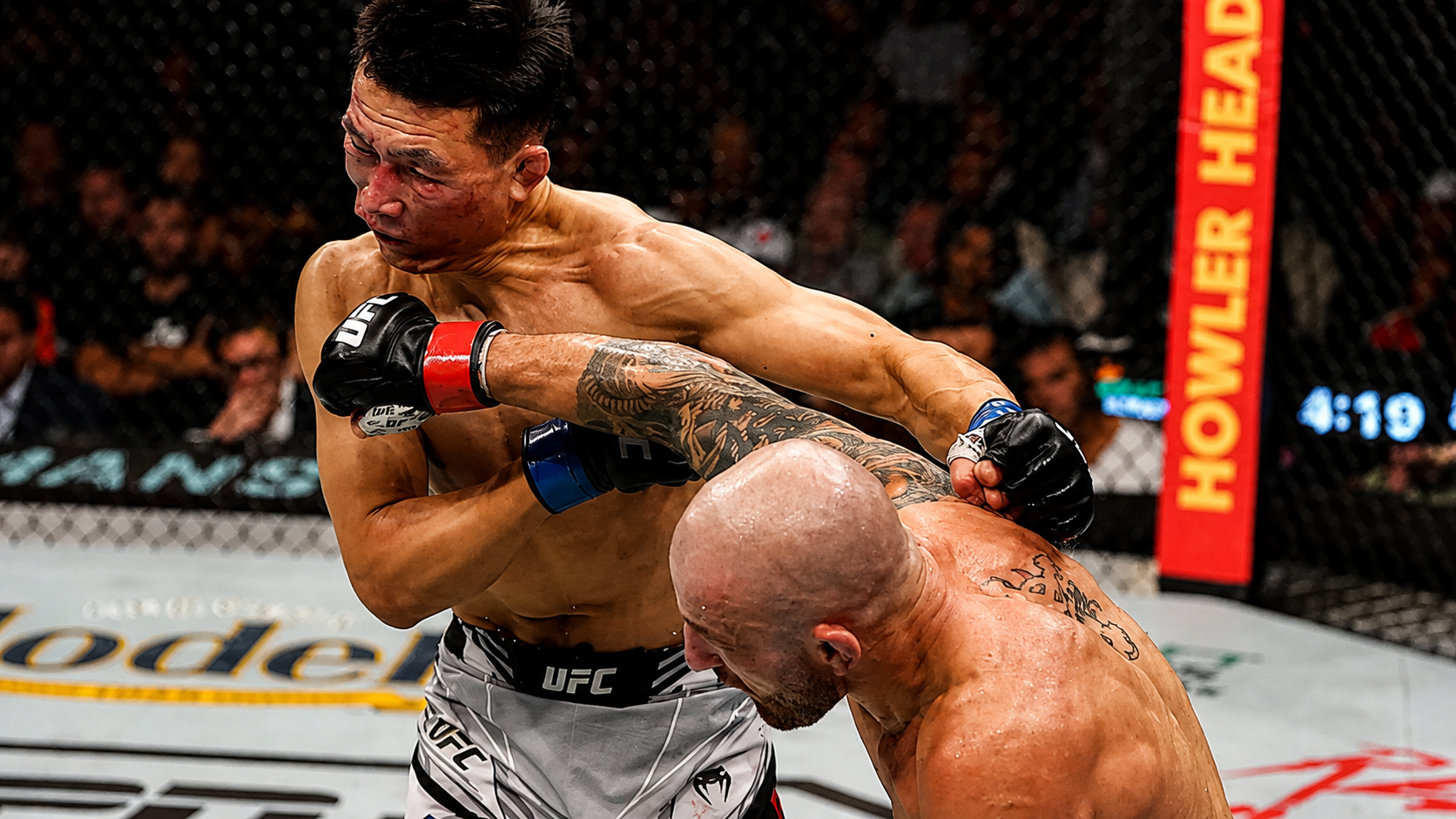 A fighter's head snapping back as the punch lands.