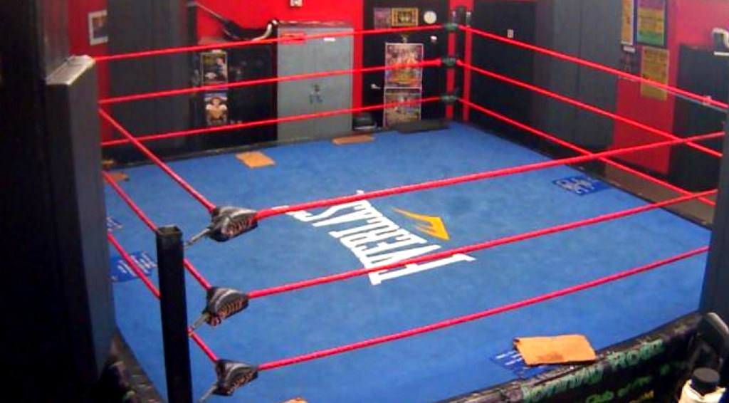 An empty ring under harsh lights, from fighting's older world